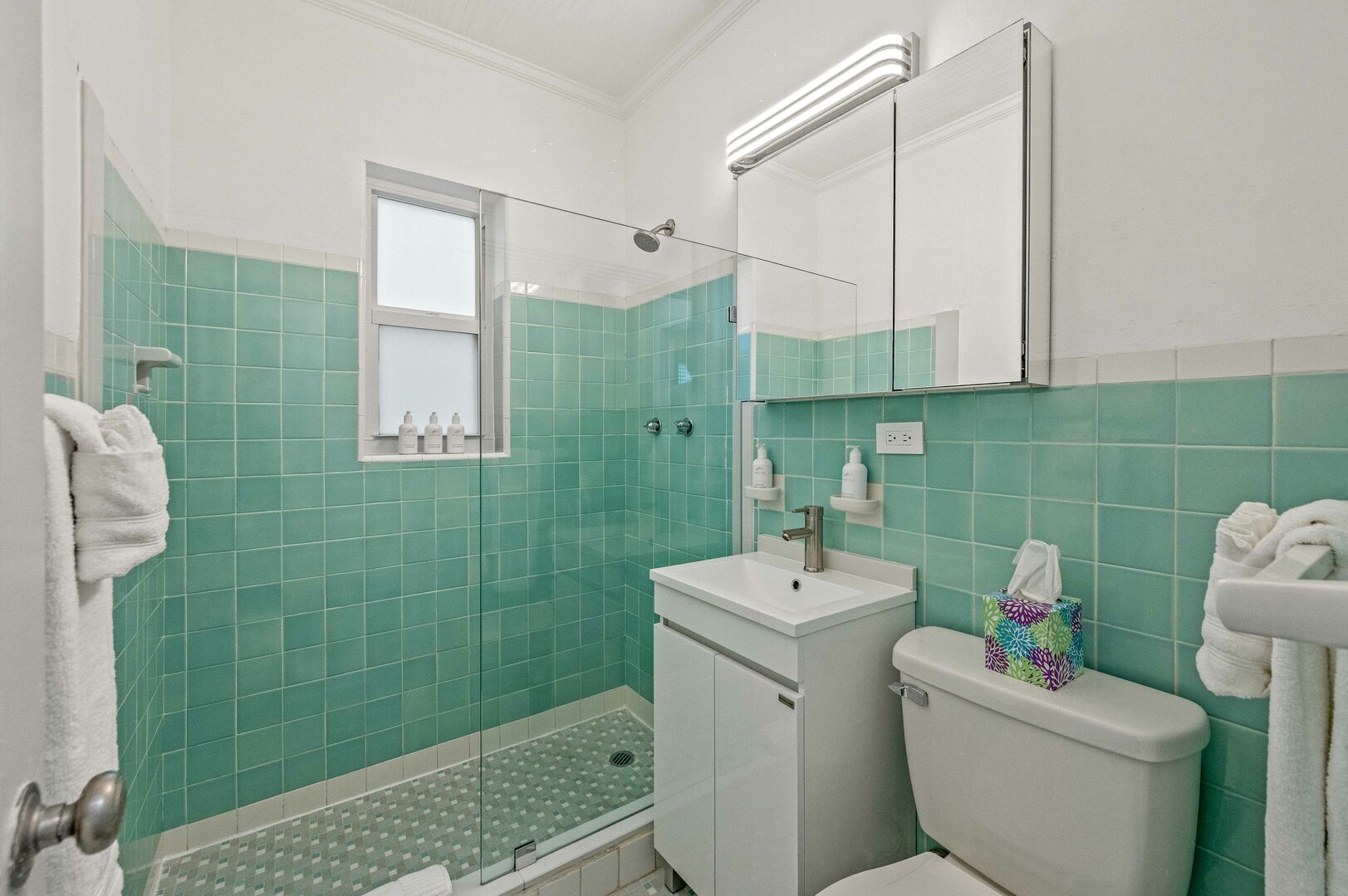 The bathroom features a walk-in shower.