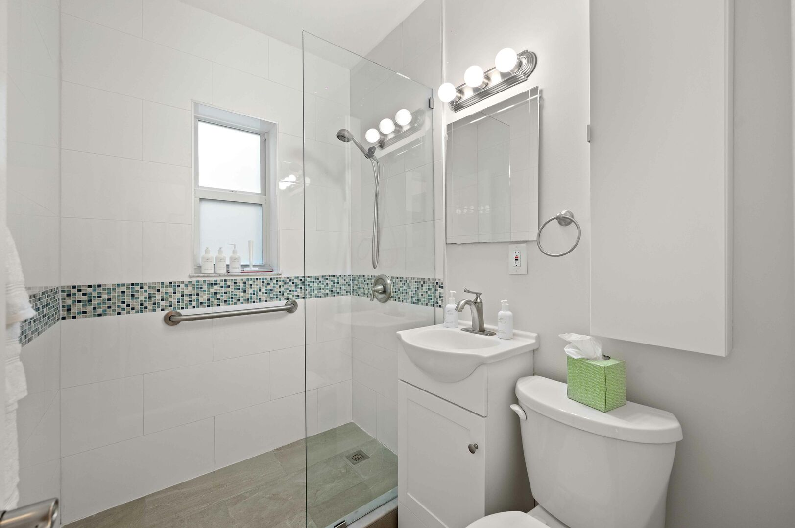 The bathroom features a walk-in shower and plenty of storage space.