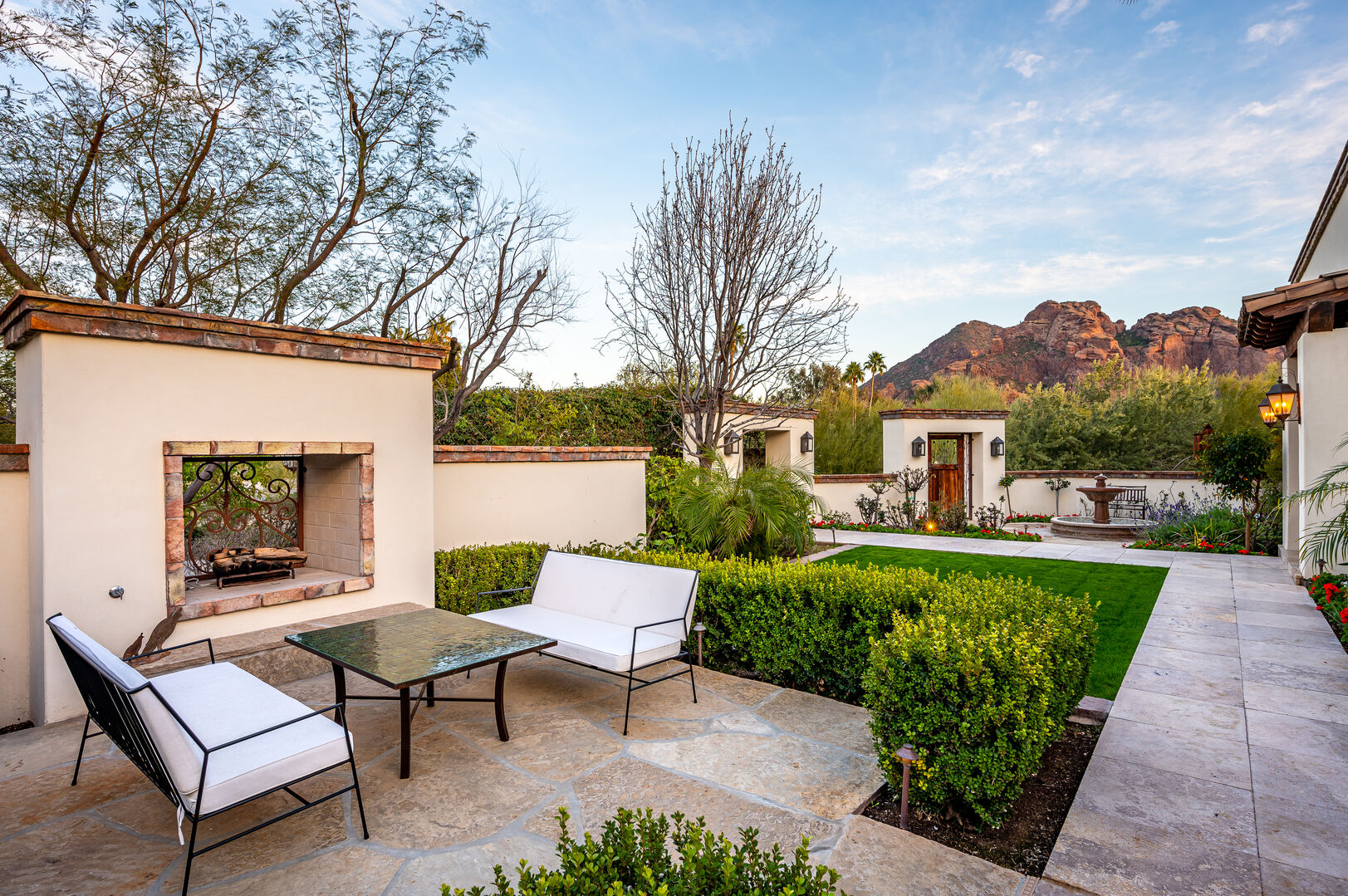 Outside fireplace and seating with views of Camelback Mountain.