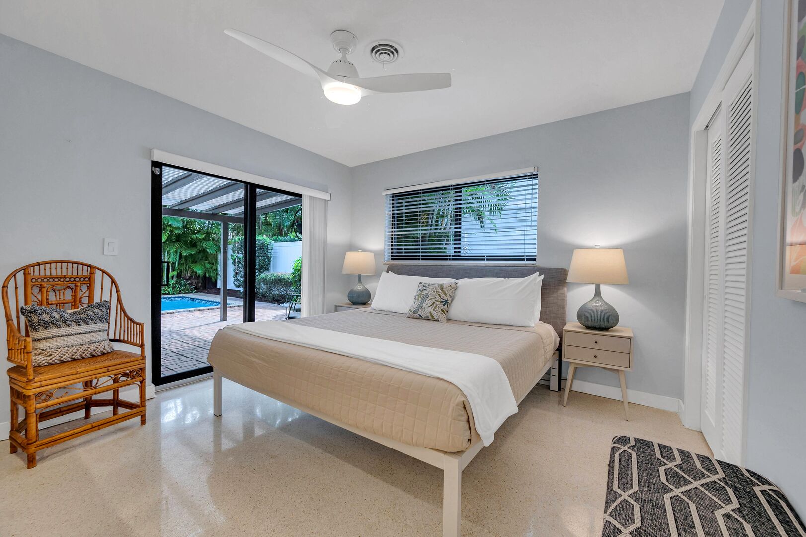 The third bedroom with king size bed, smart TV, and an amazing view with private access to the heated pool, patio and lush surroundings.