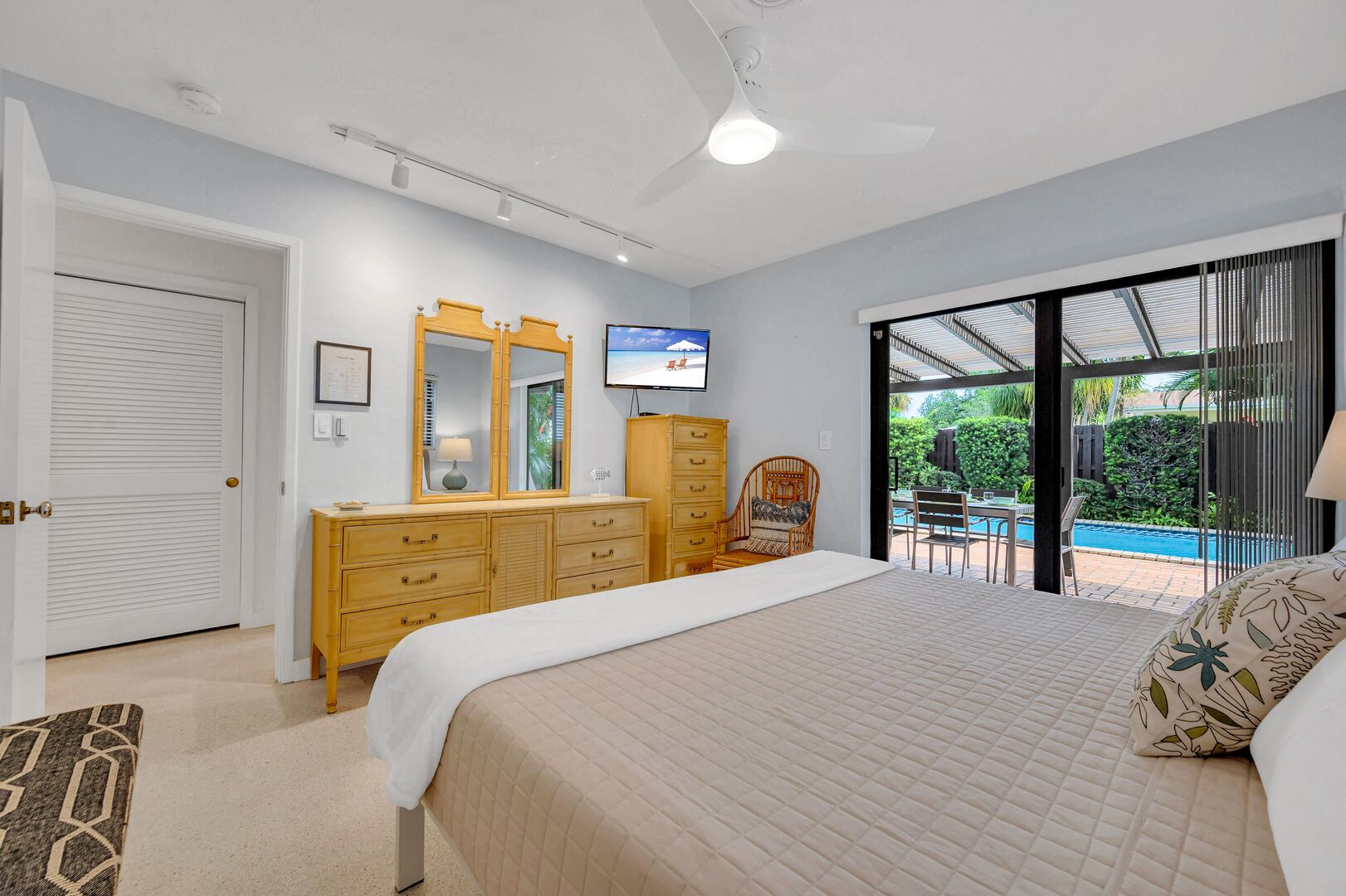 The third bedroom with a king size bed and smart TV boasts a gorgeous view with direct access to the heated pool.