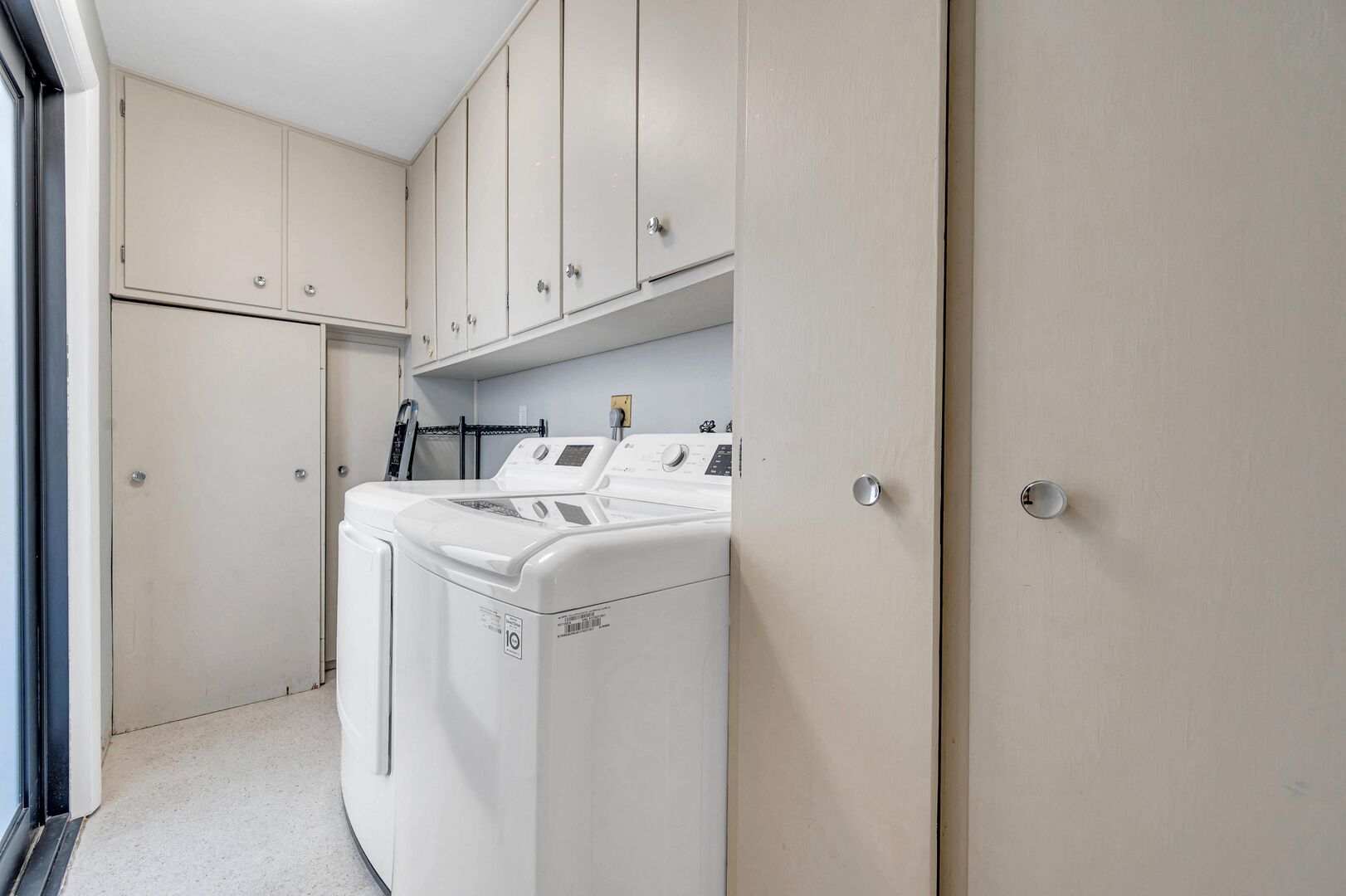 Laundry room equipped with a washer and dryer.