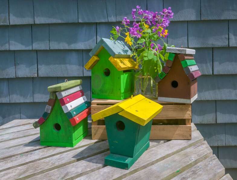 Beautiful birdhouses are located around the home.