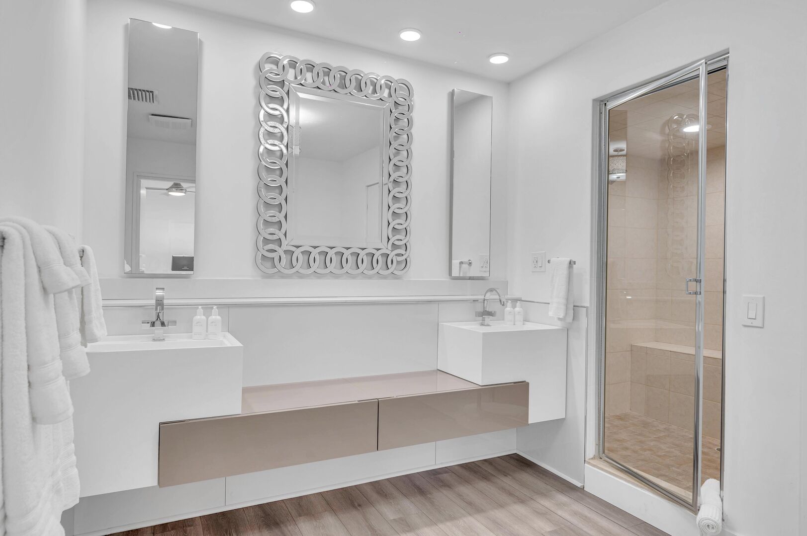 The luxurious primary bathroom features a double vanity and shower.