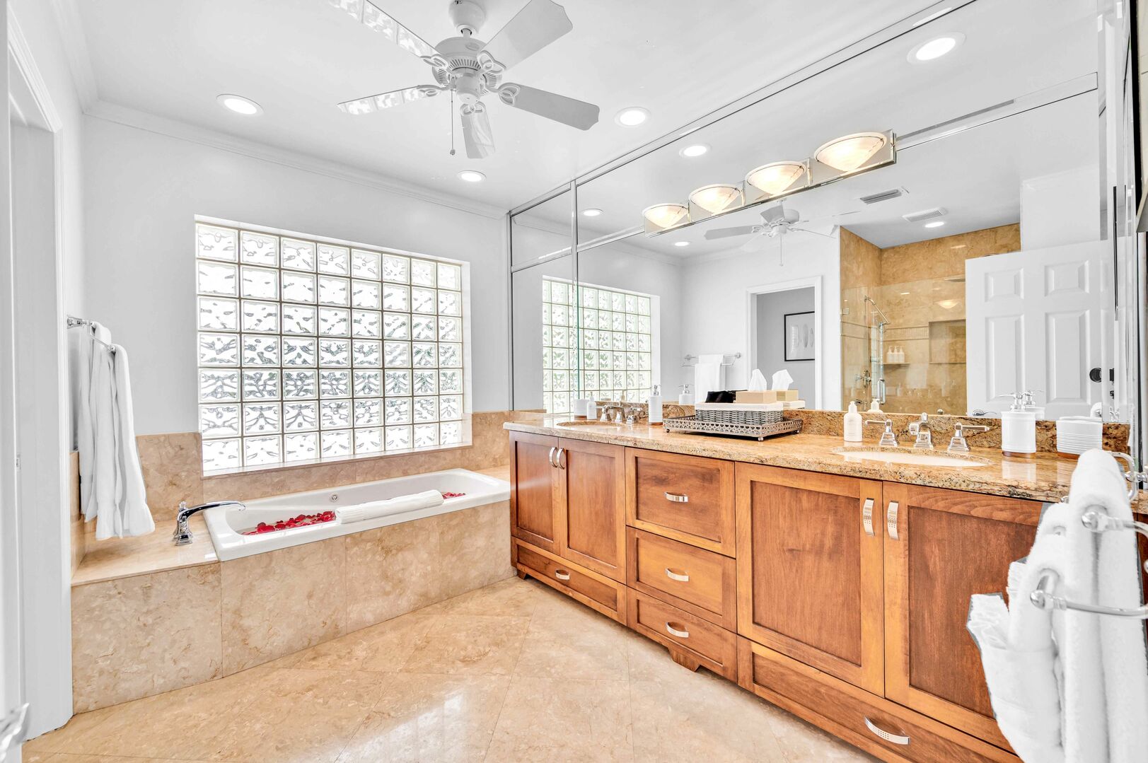 The master bathroom features a double vanity, large soaking tub and separate shower.