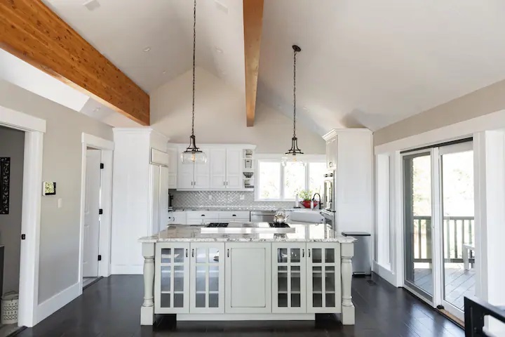 A beautiful oversized island is the centerpiece of this amazing kitchen.  The island contains a chef's Wolf range with Griddle.  Just off the Kitchen is the rear deck with seating for 10 and a large outdoor dining area.