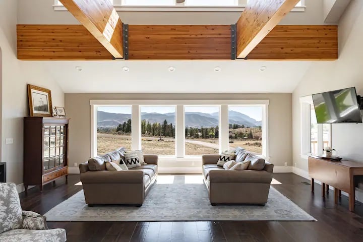 Jaw Dropping views from the main level living room will take your breath away.  A huge great room with enormous exposed wooden beams, beautiful windows and furniture, a 60