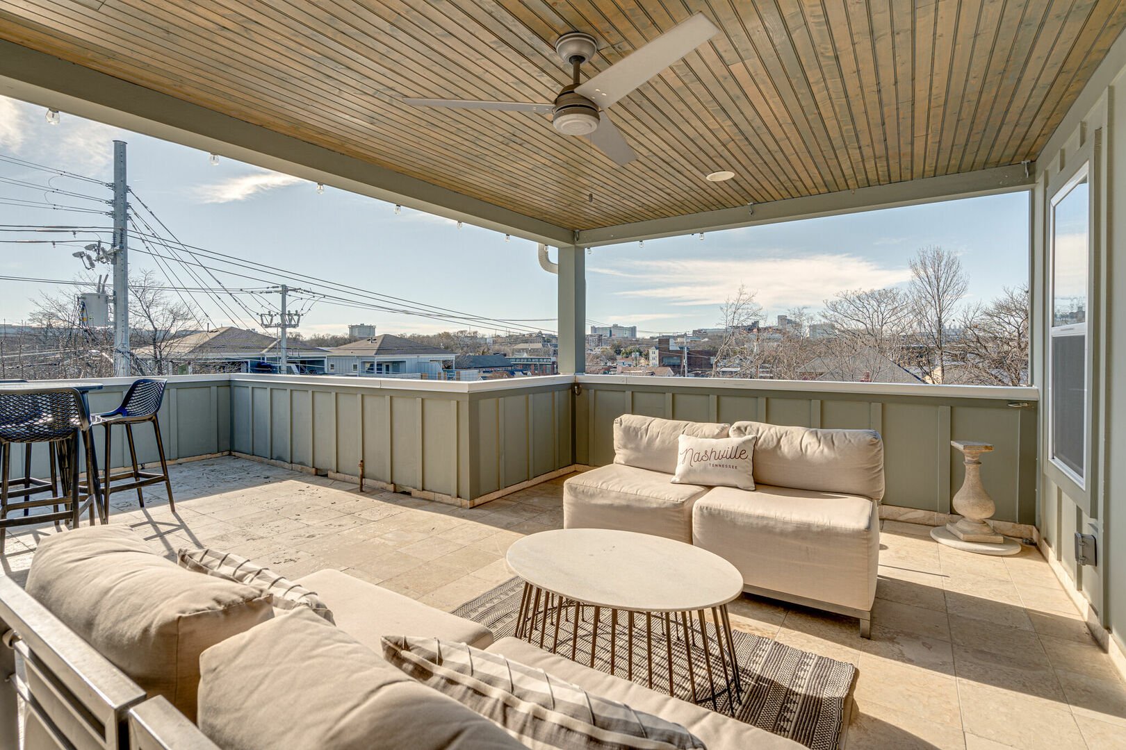 Private rooftop deck with outdoor dining, covered lounge area, ceiling fans, smart TV and views of downtown.