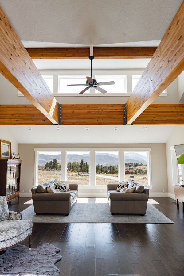 Jaw Dropping views from the main level living room will take your breath away.  A huge great room with enormous exposed wooden beams, beautiful windows and furniture, a 60