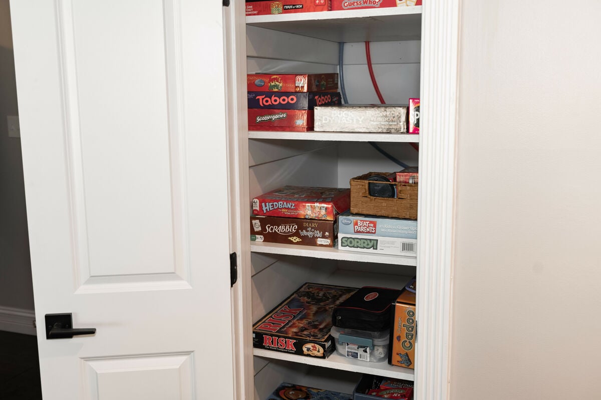 Game closet with numerous board games, puzzles, etc.
