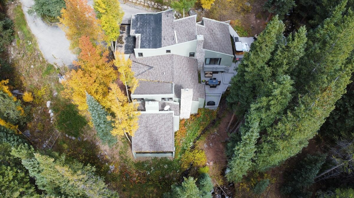 Aerial Majesty of the Estate: An aerial drone shot reveals the grandeur of Creekside Chateau, showcasing the expansive home and its thoughtful layout within the breathtaking landscape.