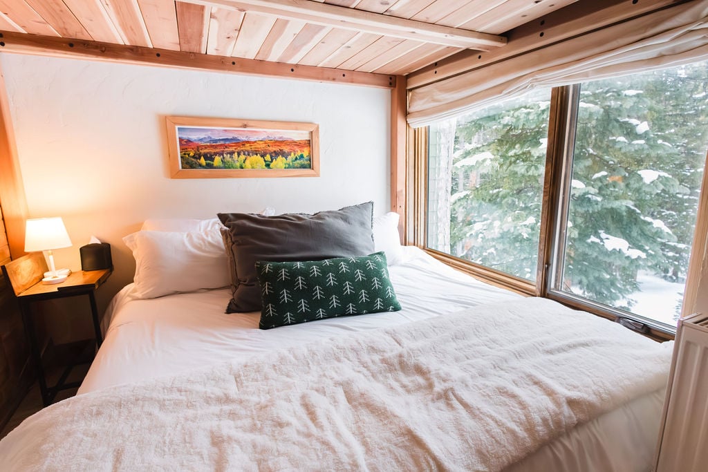 Special Nook with Incredible Views: The lower king platform bed, with its loft overhead, offers a special nook within the chateau.