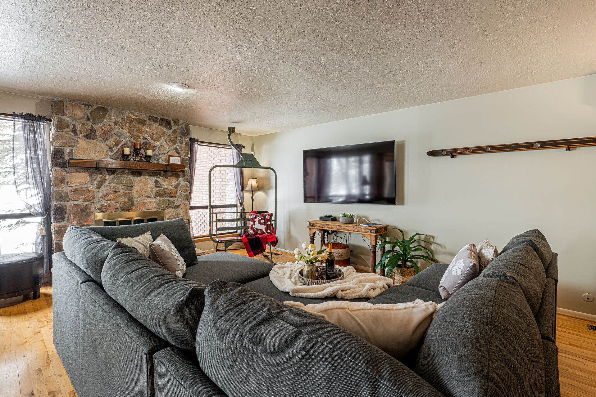 Main Level Living Room with  plush sectional, a warm wood-burning fireplace, Smart TV, and your very own chairlift