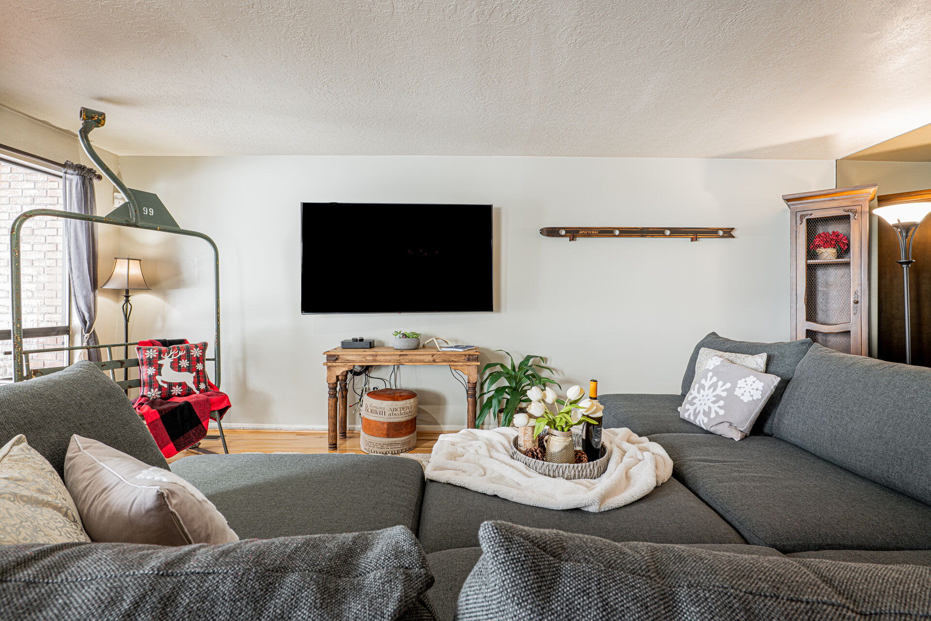 Main Level Living Room with  plush sectional, a warm wood-burning fireplace, Smart TV, and your very own chairlift