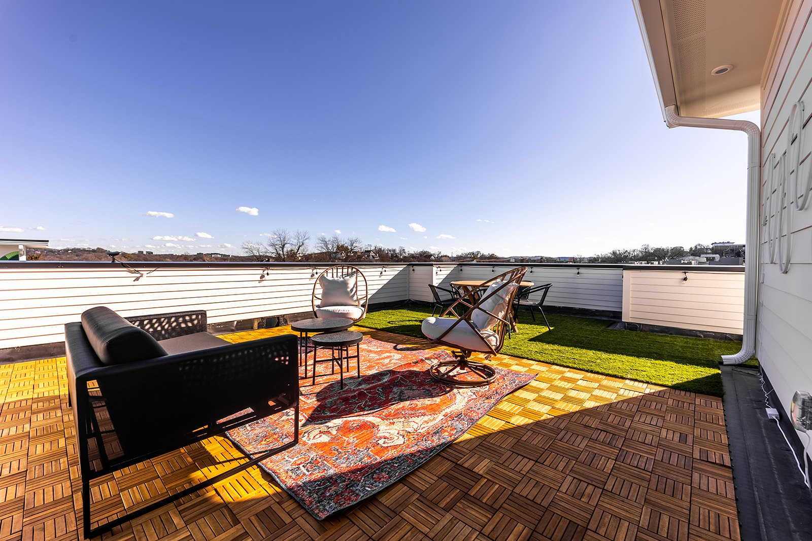 Private rooftop deck with lounge area, and outdoor dining.