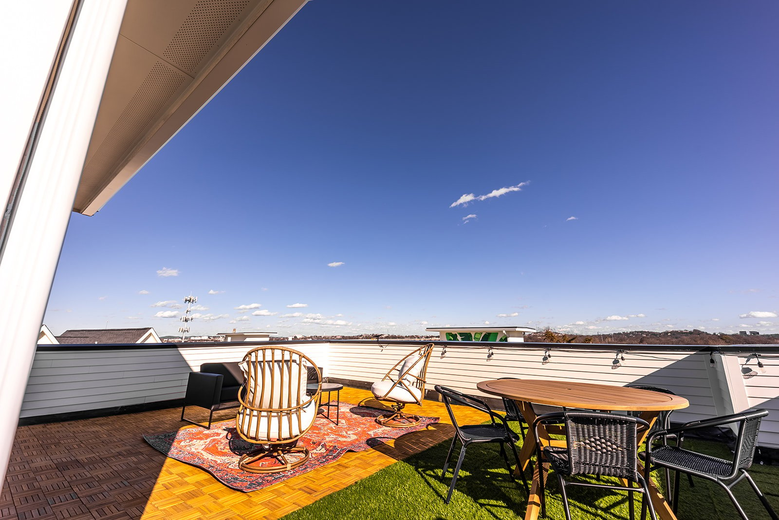 Private rooftop deck with lounge area, and outdoor dining.
