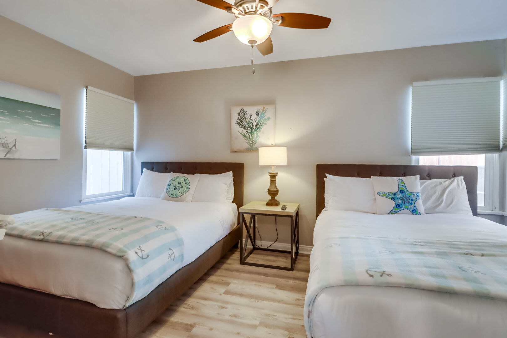 Lower level guest bedroom with 2 queen beds, ceiling fan, closet and dresser storage, and smart TV