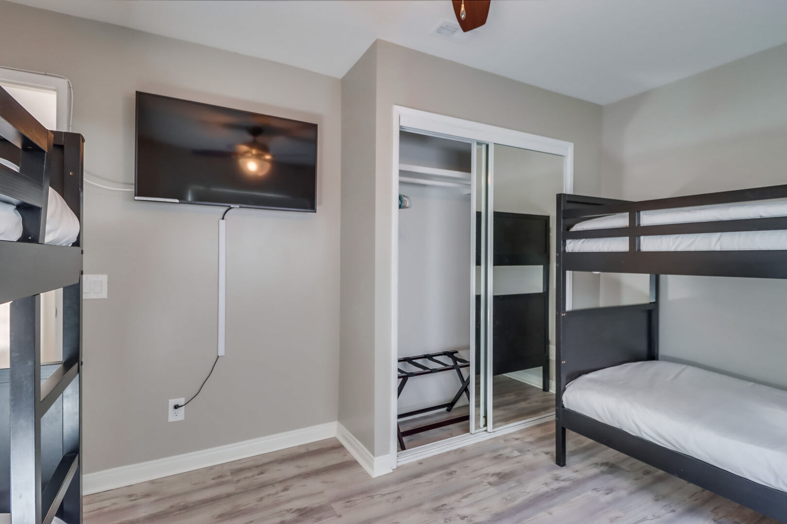 Guest bedroom with 2 sets of twin bunk beds! Great spot for kids with storage and smart TV