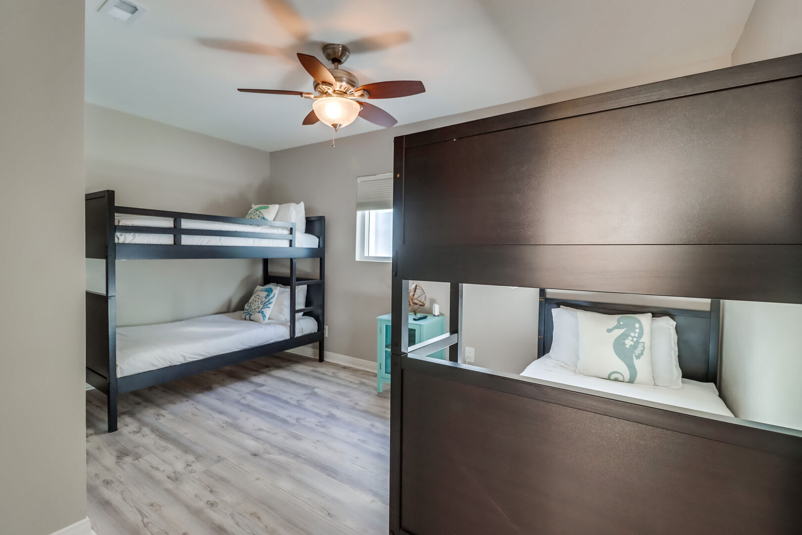 Second guest room on the second level with 2 sets of bunk beds with twin mattresses. Also includes a closet, smart TV and ceiling fan
