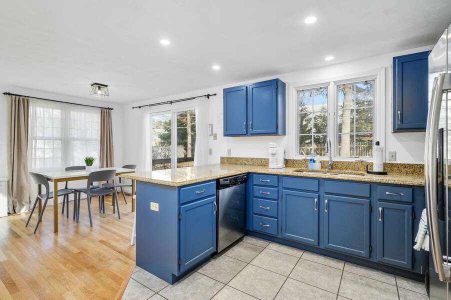 The open kitchen makes meal prep and participation an easy task - 102 White Rock Road Yarmouth Port Cape Cod - Vacation Station - NEVR