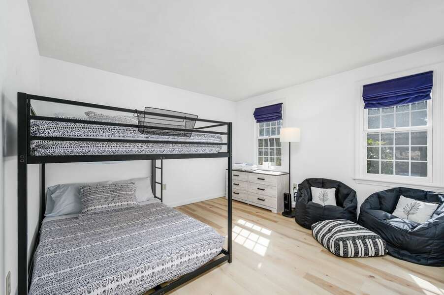 Bedroom #1 on the main level provides a full-over-full bunk bed and seating area - 102 White Rock Road Yarmouth Port Cape Cod - Vacation Station - NEVR
