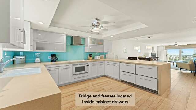 Fridge and Freezer located inside cabinet drawers, unit also has a stand alone mid-sized fridge/freezer