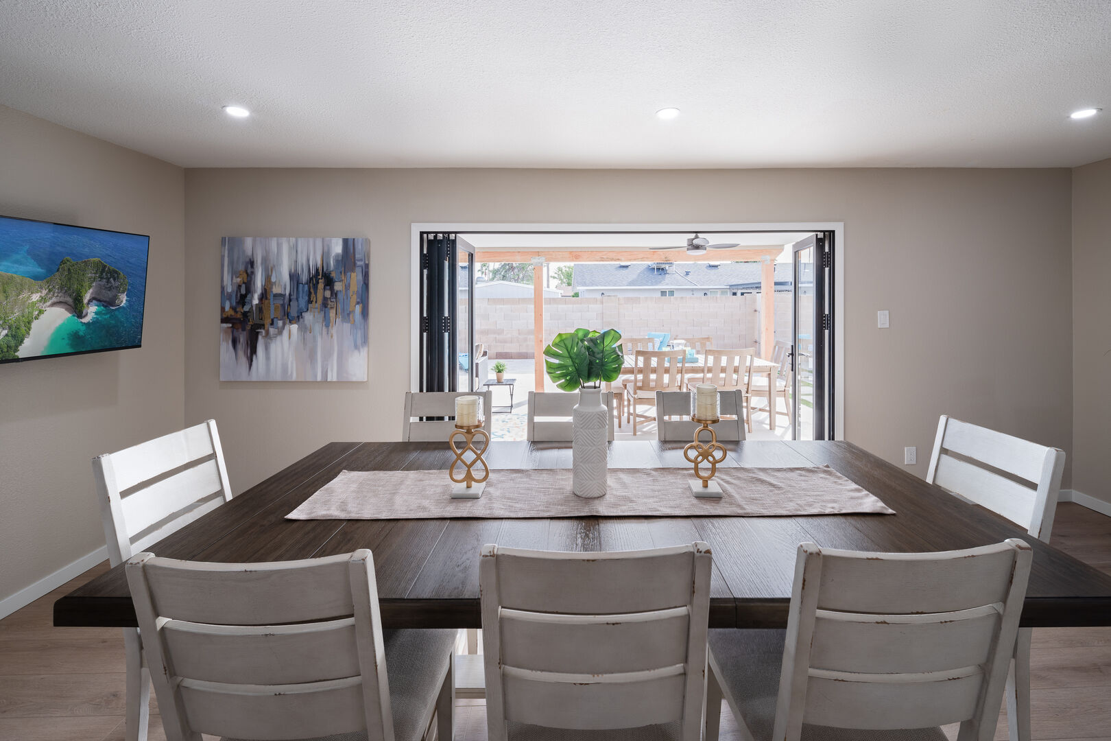Dining area in kitchen with large accordion opening doors, Smart TV, and direct access to kitchen.