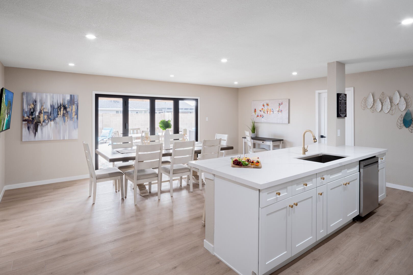 Open concept kitchen with dining room, large island, designated workspace, and fully stocked with all basic cooking essentials