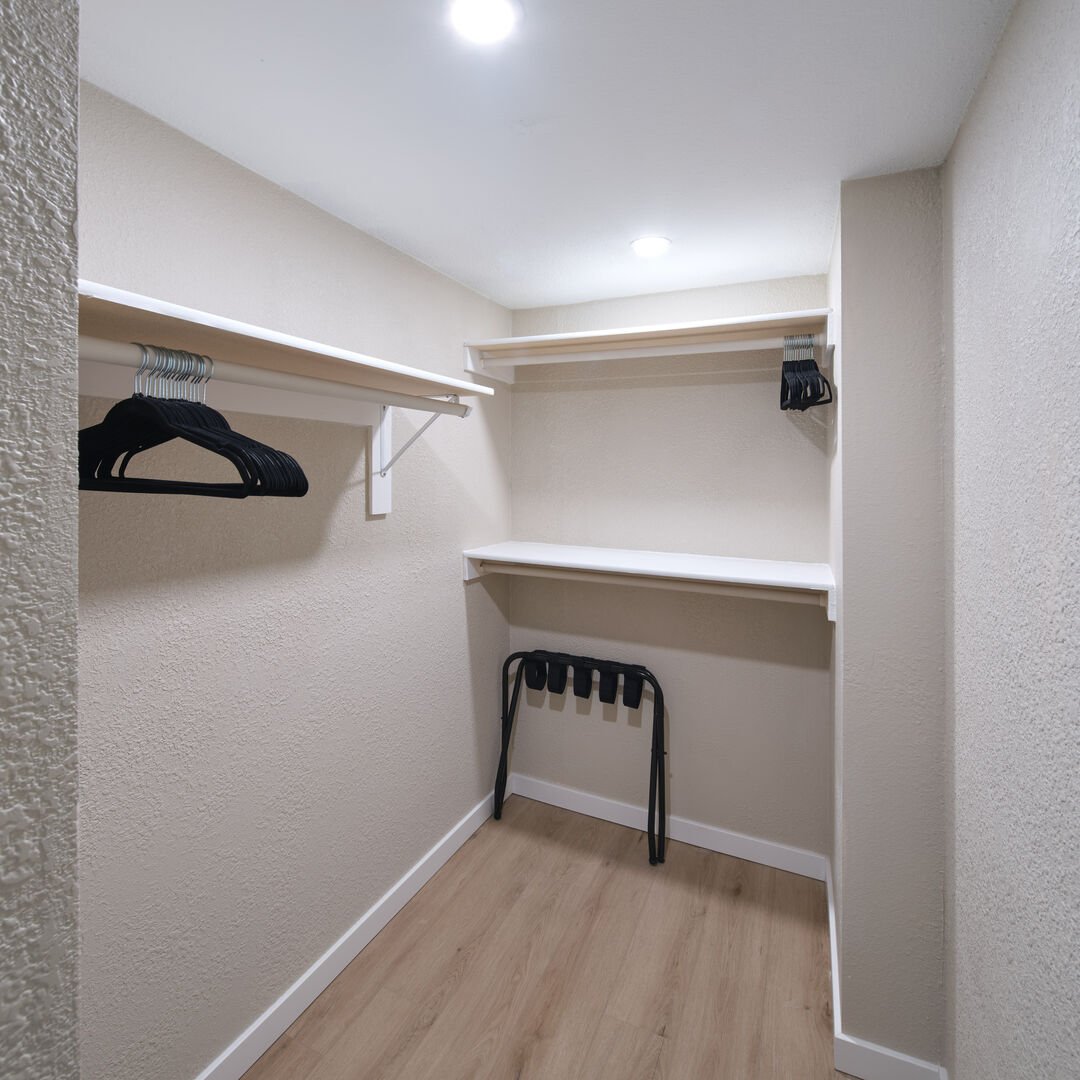 Primary bathroom with standing walk-in shower and walk-in closet
