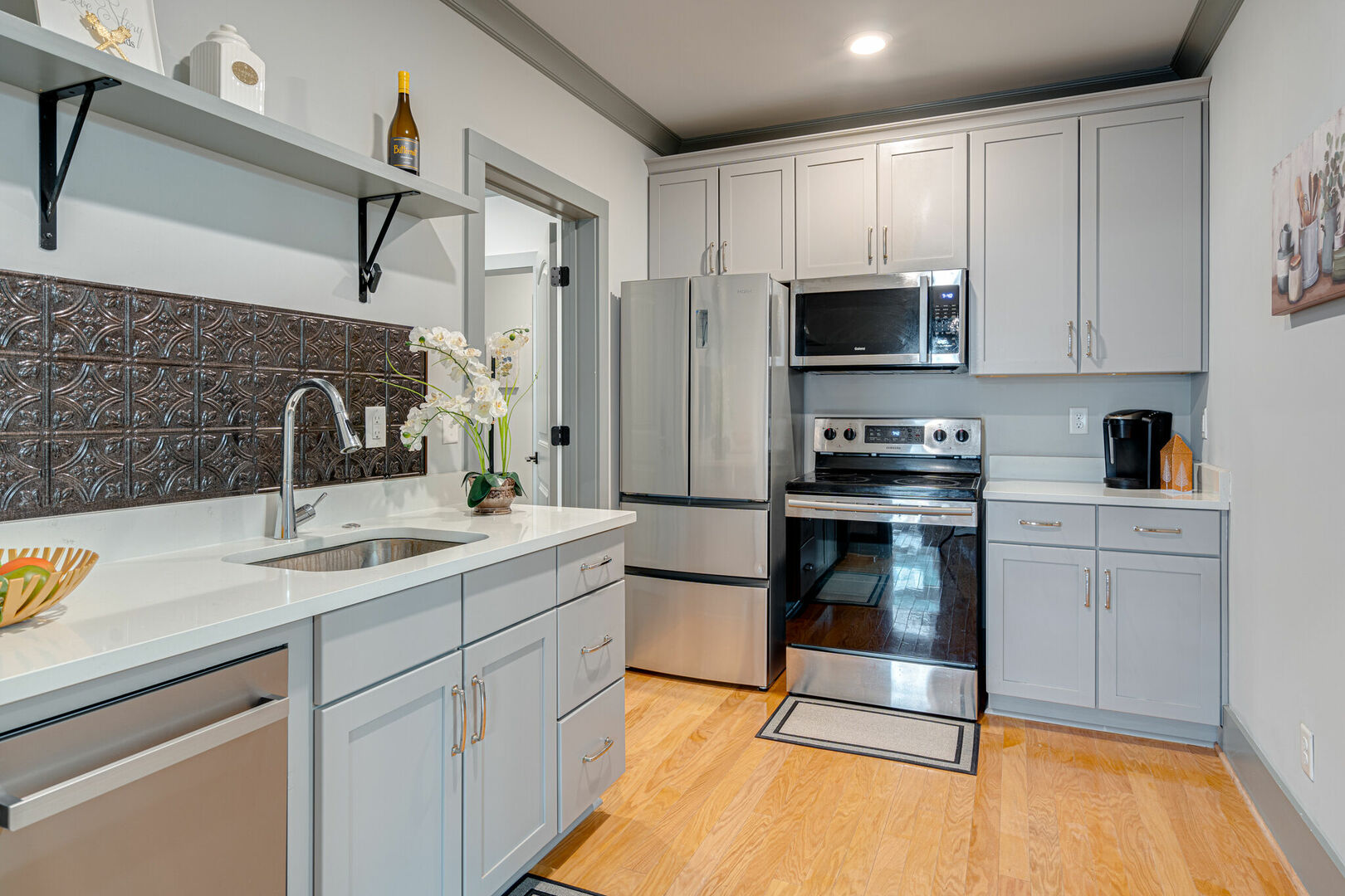 Fully equipped kitchen stocked with basic cooking essentials and stainless steel appliances.