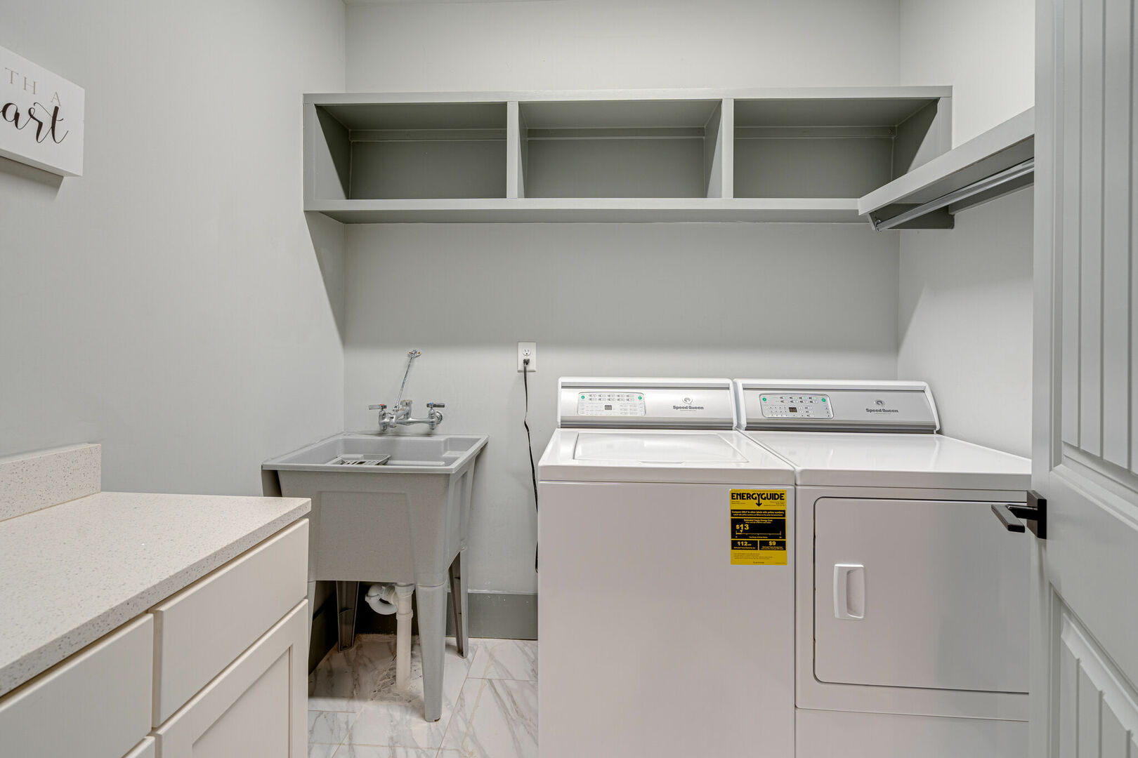 Laundry Room featuring In-Unit Washer and Dryer with Ample Storage.