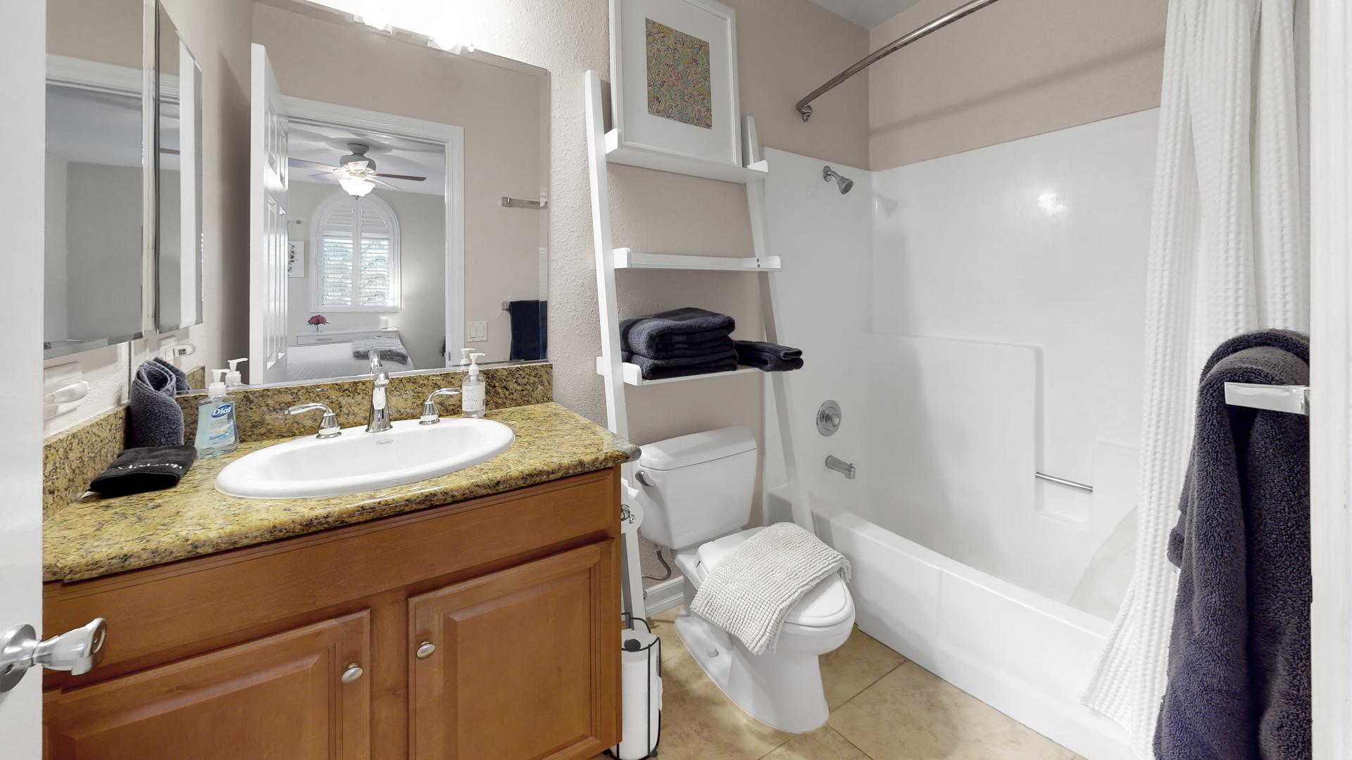 In-suite bathroom with shower-tub combo of the second master bedroom