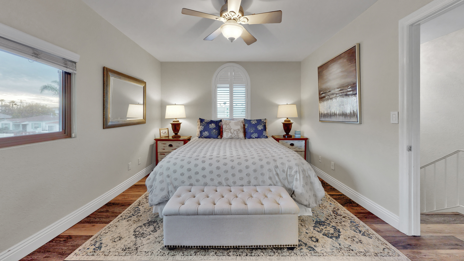 Master bedroom with king bed, ceiling fan and ample storage