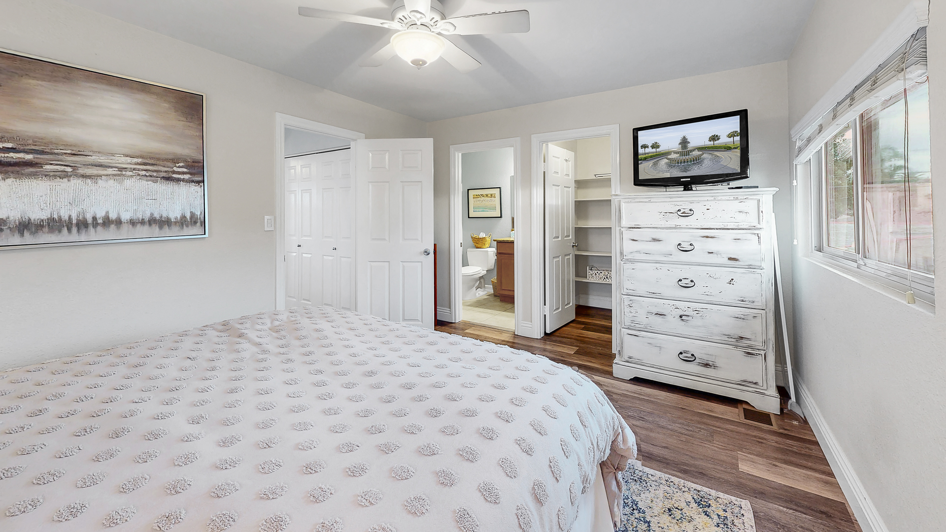 Master bedroom with dress storage, large walk-in closet, and in-suite full bathroom