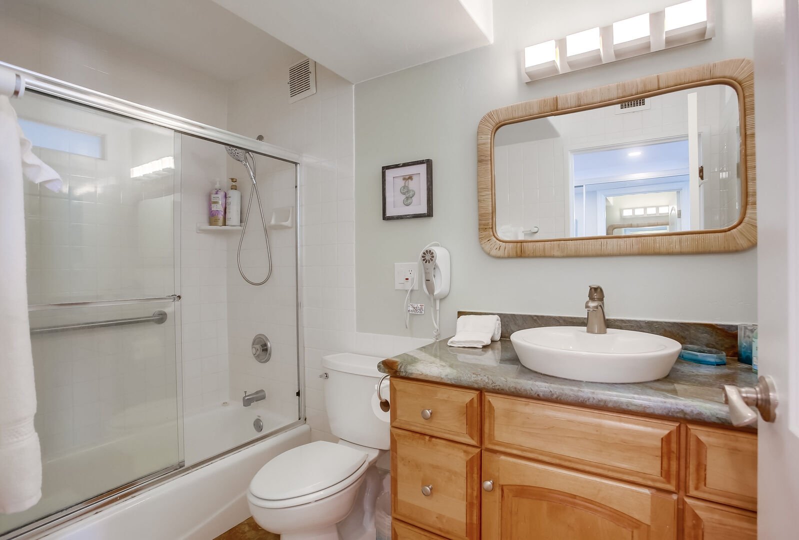 In-suite master bathroom with vanity and shower-tub combo