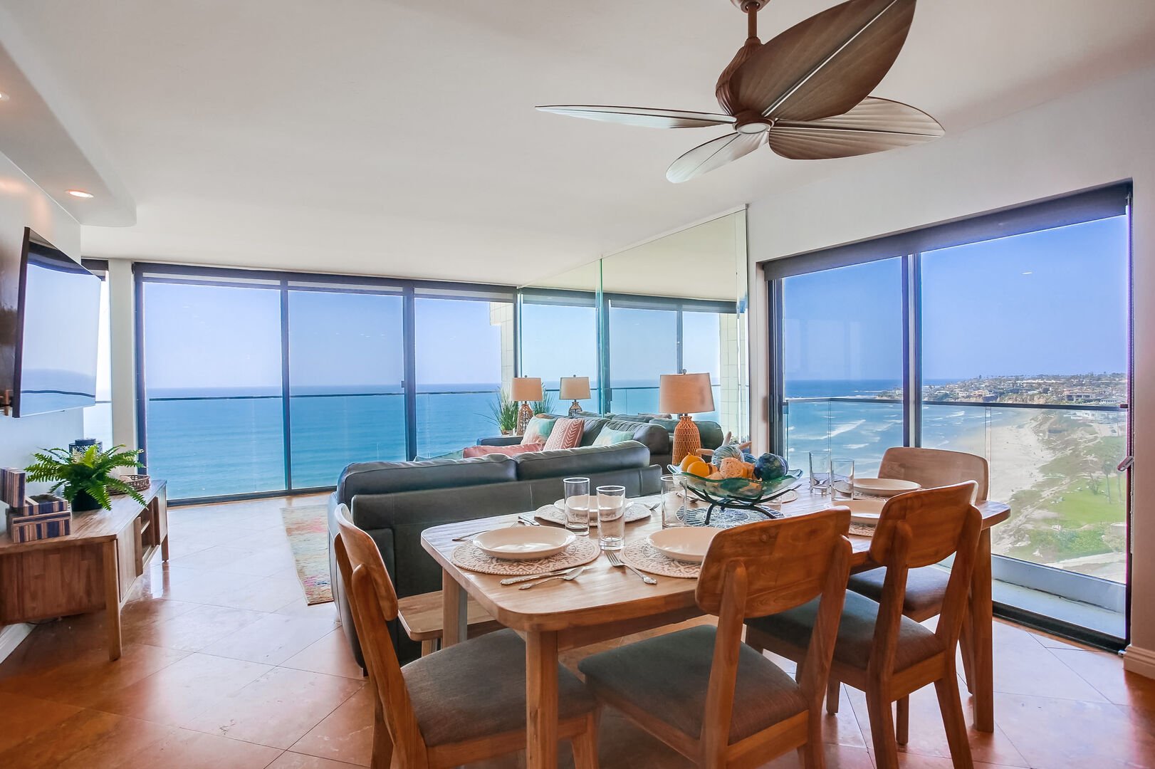 Large dining table and spacious living room with incredible north and west ocean views!