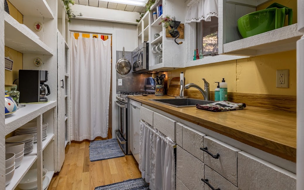 Full Galley kitchen and laundry room behind curtain