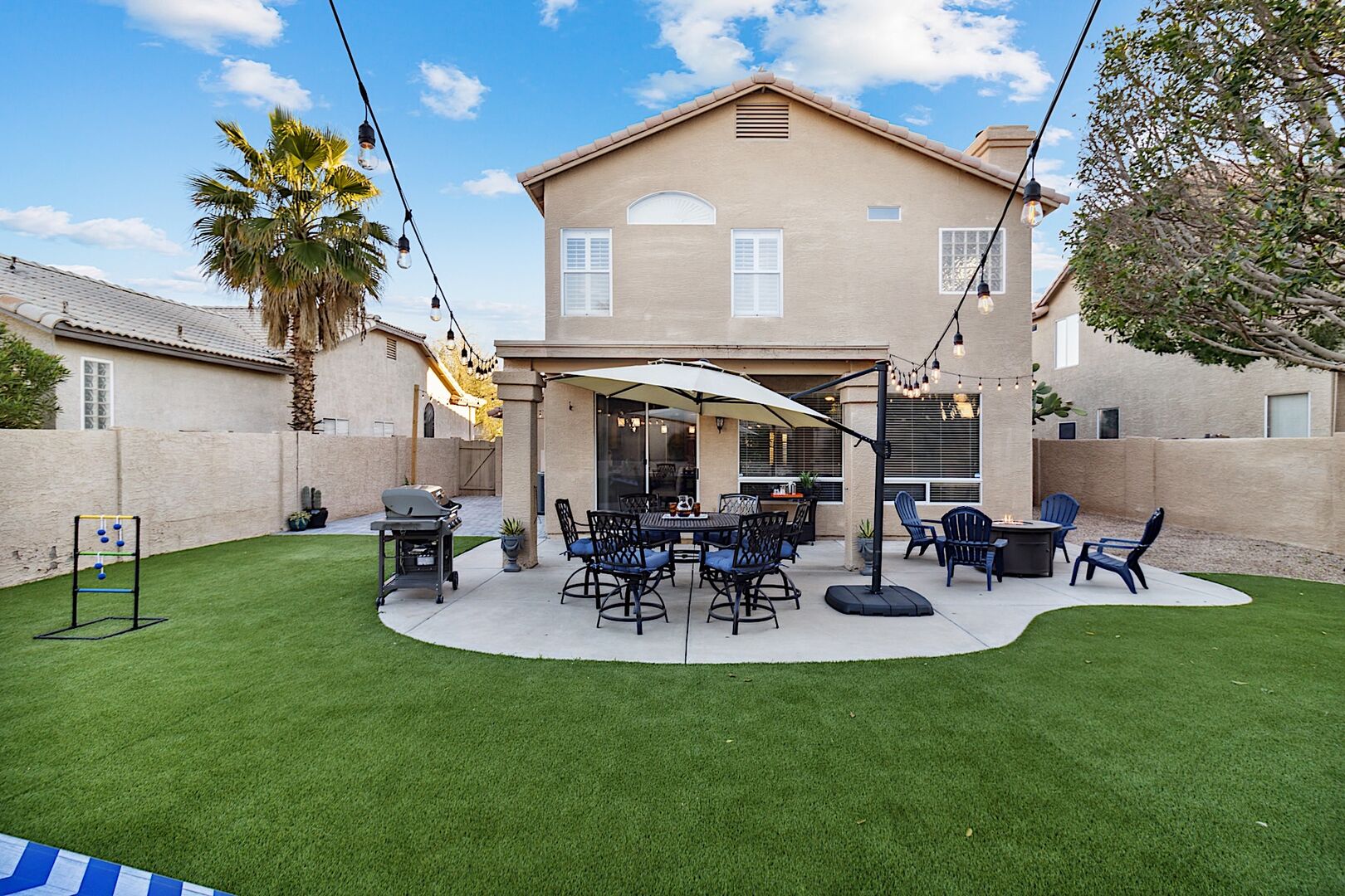 Great backyard for entertaining! BBQ Grill, Outdoor Dining Table, Fire Pit, & Yard Games like Corn Hole, Ladder Ball & Jenga!