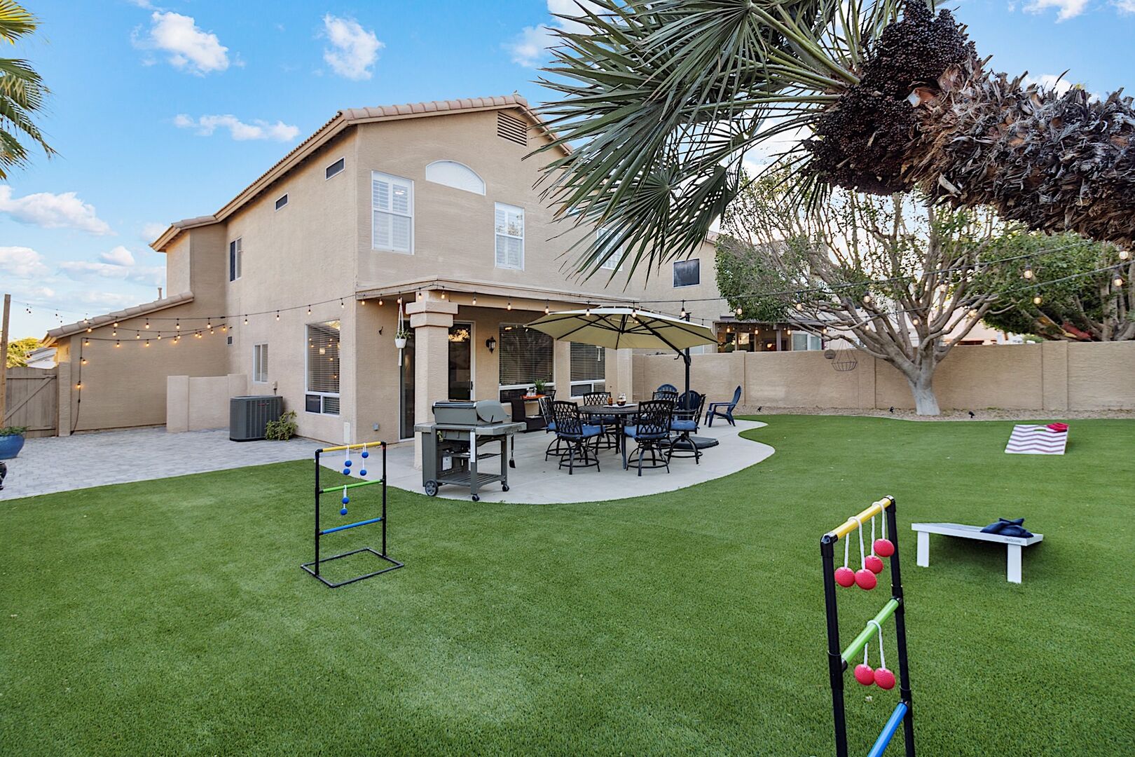 Great backyard for entertaining! BBQ Grill, Outdoor Dining Table, Fire Pit, & Yard Games like Corn Hole, Ladder Ball & Jenga!