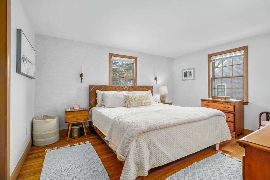 Bedroom #2 is the Primary bedroom and includes a King bed and accentuated with natural materials - 20 Vacation Lane Harwich Cape Cod - At Last - NEVR