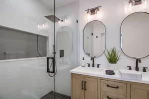 Master bathroom with large walk-in shower, rainfall shower head with handheld nozzle, and beautiful dual vanity