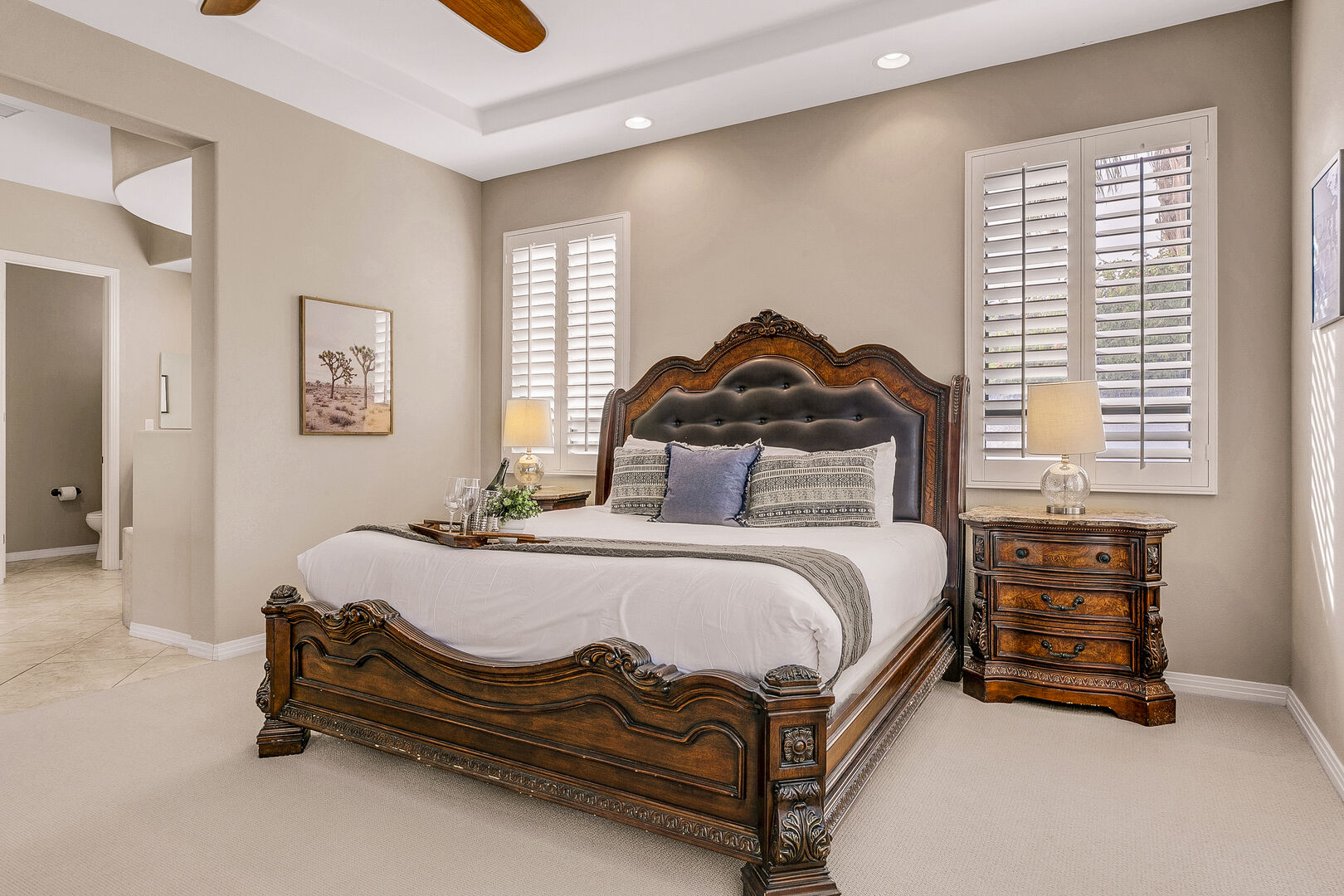Master Suite 1 is located to the left of entrance doors and features a King-sized Bed.