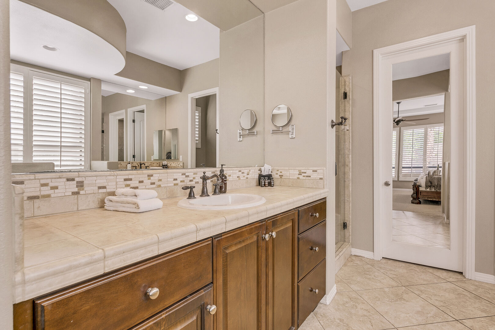 The private, en suite bathroom features a soaking tub, tile shower and his and her vanity sinks.