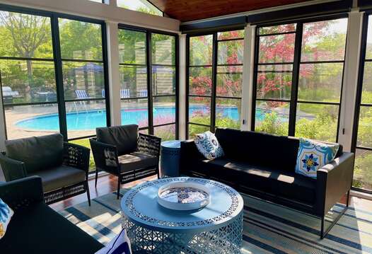 3 season porch with screens overlooks the pool and is just off the dining room