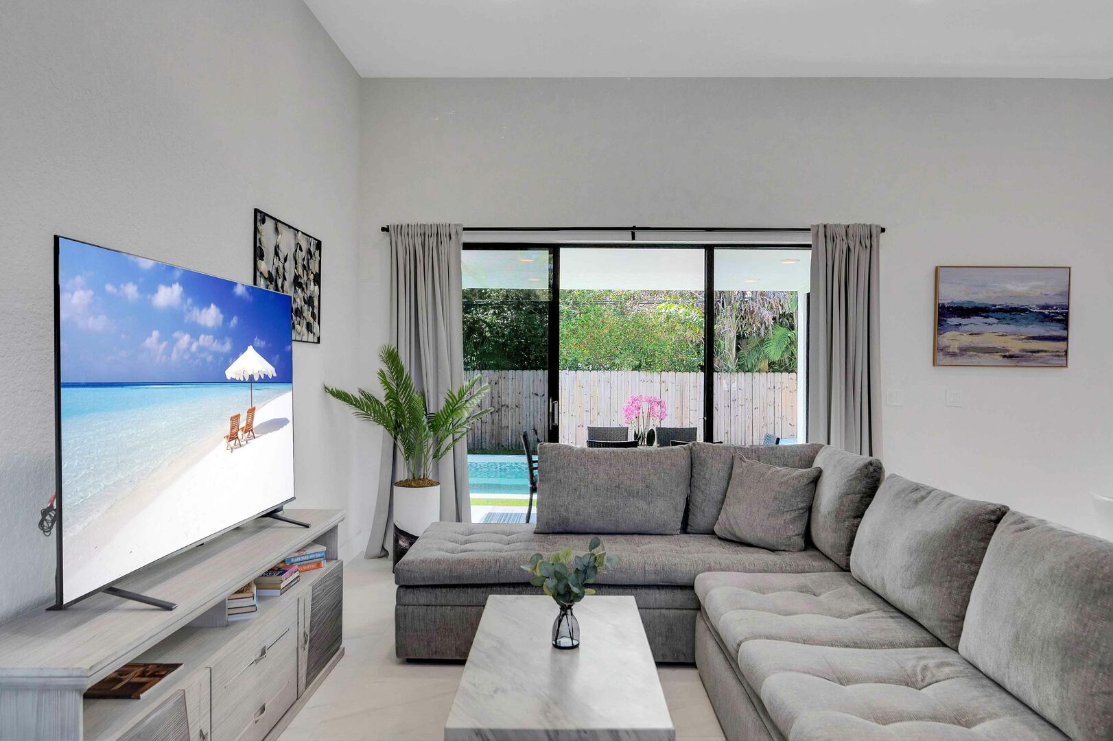 The living space features a comfortable lounge area and smart TV.