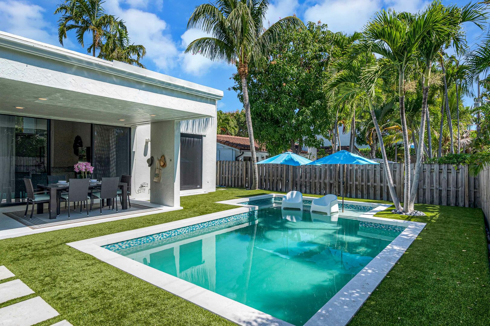 The private garden features a heated pool with loungers, tanning shelf and al fresco dining.
