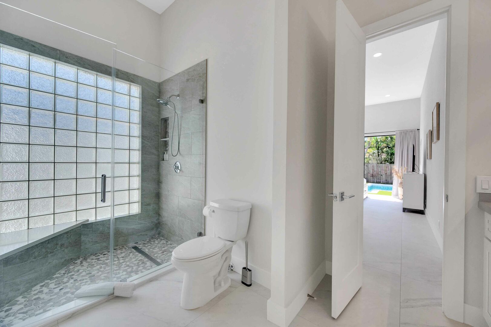 The en-suite primary bathroom features two sinks an a walk-in shower.