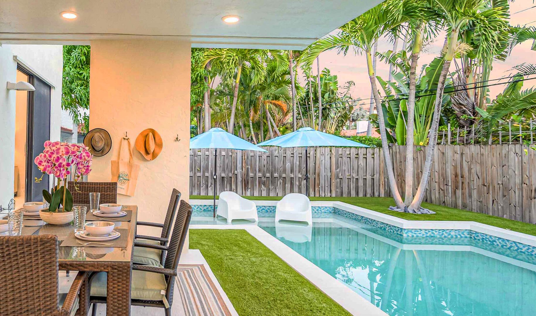 Outside you will enjoy a covered patio with a dining table. The private garden features a heated pool with lounges and al fresco dining.