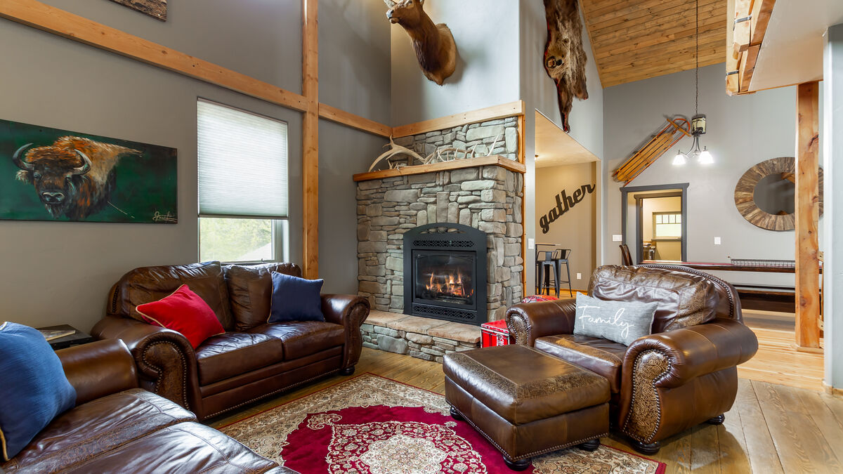 The 2nd floor boasts a spacious, inviting sitting area. Relax next to the stone fireplace, enjoying the cozy ambiance. The kitchen is conveniently located nearby for snacks. This space is sure to become one of your favorite spots in the house.