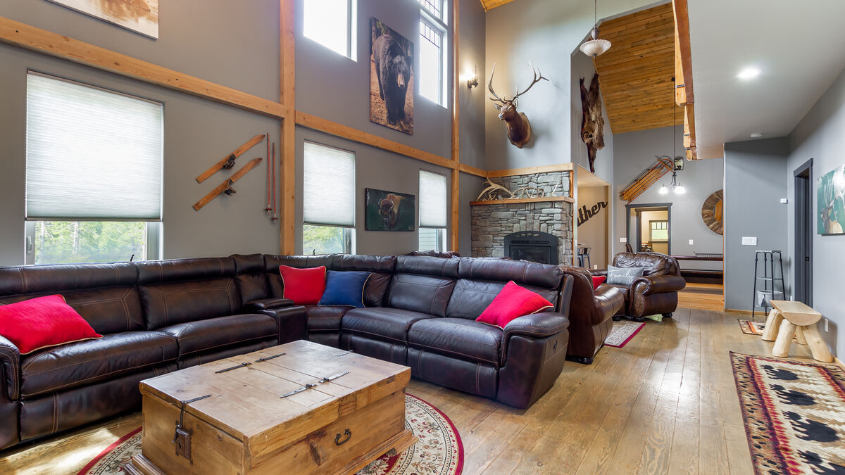 The second floor of this stunning property offers yet another cozy and inviting space that is perfect for relaxing and unwinding. This section features a spacious and comfortable sectional perfectly positioned to face the large 75-inch TV.